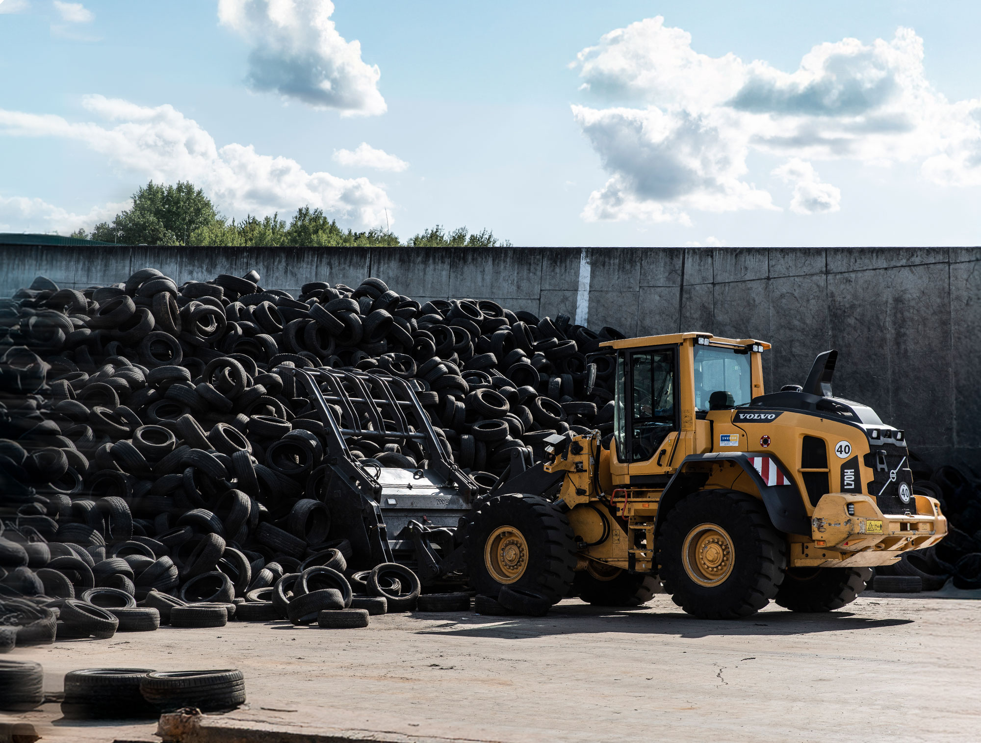 Radlader bewegt große Menge Altreifen auf Recyclinganlage – Reifenrecycling und Materialrückgewinnung bei PVP